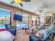 Enclosed lanai with view of the pool, a ceiling fan, and comfortable wicker seating at 18790 Countryman Ave, Port Charlotte, FL 33948