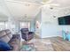 Bright living room with comfortable seating, ceiling fan, and access to the outdoor area at 18790 Countryman Ave, Port Charlotte, FL 33948