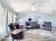 Spacious living room featuring comfortable sofas, ceiling fan, and stylish decor at 18790 Countryman Ave, Port Charlotte, FL 33948