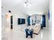 Open-concept living room with TV, white sofa, bright floors and decor at 18790 Countryman Ave, Port Charlotte, FL 33948