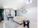 Spacious living room featuring a sofa, tile flooring, and ocean themed decor at 18790 Countryman Ave, Port Charlotte, FL 33948