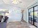 Comfortable living room with stylish gray floors, decor shelves, and sliding doors to the lanai at 18790 Countryman Ave, Port Charlotte, FL 33948