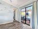 Open living room featuring decor shelves and sliding doors to a screened lanai with pool view at 18790 Countryman Ave, Port Charlotte, FL 33948