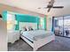 Bright main bedroom featuring a ceiling fan and sliding glass door to the lanai at 18790 Countryman Ave, Port Charlotte, FL 33948