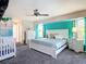 Open main bedroom with calming gray carpet, a ceiling fan, and soft natural lighting at 18790 Countryman Ave, Port Charlotte, FL 33948