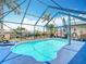 Inviting enclosed pool area with sparkling water and tropical landscaping at 18790 Countryman Ave, Port Charlotte, FL 33948