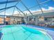 Beautiful in-ground pool is enclosed with screens, offering a clear view of the outdoors at 18790 Countryman Ave, Port Charlotte, FL 33948