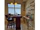 Entertain at home with the bar featuring seating, marble countertop and bottle storage at 19 Medalist Way, Rotonda West, FL 33947