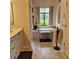Open bathroom showcasing a tub underneath a window with a garden view at 19 Medalist Way, Rotonda West, FL 33947