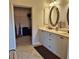 Spacious bathroom with double sinks, a walk-in closet and tile flooring at 19 Medalist Way, Rotonda West, FL 33947