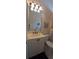 The bathroom features a single vanity, toilet, and bright lighting under an angled ceiling at 19 Medalist Way, Rotonda West, FL 33947