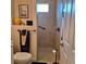 Bathroom featuring a tiled shower with glass, neutral walls, and a convenient handrail at 19 Medalist Way, Rotonda West, FL 33947