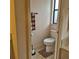 Cozy half bathroom featuring tile flooring, and a modern toilet at 19 Medalist Way, Rotonda West, FL 33947