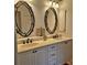 Bright bathroom with double vanity sinks and decorative mirrors, with plenty of storage at 19 Medalist Way, Rotonda West, FL 33947