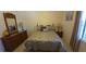 Comfortable bedroom with wooden furniture and a large window providing natural light at 19 Medalist Way, Rotonda West, FL 33947