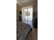 Bedroom featuring sliding glass doors leading to an outdoor pool area at 19 Medalist Way, Rotonda West, FL 33947