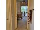 A view from a hallway leading into the bedroom with slider access to the lanai at 19 Medalist Way, Rotonda West, FL 33947
