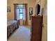 This carpeted bedroom has a window, dresser, mirror, and a television at 19 Medalist Way, Rotonda West, FL 33947