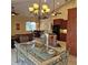 Bright dining room features tile flooring and bar with adjacent kitchen at 19 Medalist Way, Rotonda West, FL 33947
