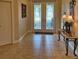 Welcoming foyer with decorative glass double doors and tiled flooring at 19 Medalist Way, Rotonda West, FL 33947