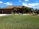 Charming home with tropical landscaping, well-maintained lawn, and a spacious driveway at 19 Medalist Way, Rotonda West, FL 33947