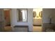 Hallway showcasing connections to laundry room and bathrooms, with vanity for added convenience at 19 Medalist Way, Rotonda West, FL 33947