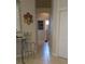 Bright hallway with tile flooring and decorative accents leading to bathroom at 19 Medalist Way, Rotonda West, FL 33947