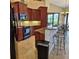 This traditional kitchen features granite counters, tile floors, and wood cabinets with modern black appliances at 19 Medalist Way, Rotonda West, FL 33947