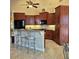 Well-appointed kitchen boasts wood cabinets, breakfast bar, and stainless-steel appliances at 19 Medalist Way, Rotonda West, FL 33947