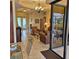 Bright living room featuring leather seating, tile floors, and access to the lanai at 19 Medalist Way, Rotonda West, FL 33947