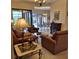 Open-concept living room with leather seating and views of the lanai at 19 Medalist Way, Rotonda West, FL 33947