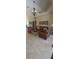 Spacious living room with neutral tones, a decorative tray ceiling, and tile flooring at 19 Medalist Way, Rotonda West, FL 33947