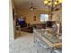 Bright living room boasts tile flooring, ceiling fan, and an open-concept layout at 19 Medalist Way, Rotonda West, FL 33947