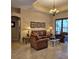 Cozy living room showcasing leather furniture and a decorative ceiling at 19 Medalist Way, Rotonda West, FL 33947