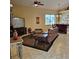 Cozy living room features tile flooring, comfortable seating, and entertainment center at 19 Medalist Way, Rotonda West, FL 33947