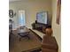 Cozy living room boasts tile flooring, entertainment center, and comfortable seating at 19 Medalist Way, Rotonda West, FL 33947
