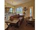 Bright living room features hardwood floor, comfortable seating, and adjacent patio doors at 19 Medalist Way, Rotonda West, FL 33947