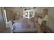 Bright main bedroom with elegant furnishings, including a large bed, dresser, and a mirror at 19 Medalist Way, Rotonda West, FL 33947