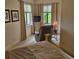 Comfortable primary bedroom with a relaxing recliner with natural light coming from two windows at 19 Medalist Way, Rotonda West, FL 33947