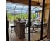 Screened in patio with outdoor seating with view of backyard and pool at 19 Medalist Way, Rotonda West, FL 33947