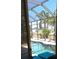 Inviting view of a sparkling pool and lush backyard oasis from the screened-in porch at 19 Medalist Way, Rotonda West, FL 33947