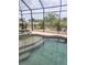 Beautiful screened-in pool and spa offer relaxation and gorgeous backyard views at 19 Medalist Way, Rotonda West, FL 33947