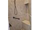 A tiled walk-in shower with a built-in seat also includes a hand rail and shower head at 19 Medalist Way, Rotonda West, FL 33947