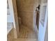 A tiled walk-in shower features a built-in seat and a bronze towel rack at 19 Medalist Way, Rotonda West, FL 33947
