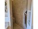 A tiled walk-in shower features a built-in seat and a bronze towel rack at 19 Medalist Way, Rotonda West, FL 33947