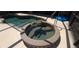 Inviting in-ground spa and pool featuring decorative tile and sunny pool deck at 19 Medalist Way, Rotonda West, FL 33947