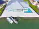 Aerial shot of a house with a pool and boat dock overlooking beautiful, open water at 1900 Illinois Ave, Englewood, FL 34224