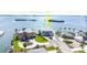Beautiful waterfront home with lush landscaping, circular driveway, and a stunning view of the surrounding water and islands at 1900 Illinois Ave, Englewood, FL 34224