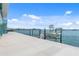 Gorgeous waterfront backyard with a concrete patio and boat lift, perfect for enjoying the water at 1900 Illinois Ave, Englewood, FL 34224