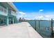 Expansive backyard featuring a concrete patio area that leads to the waterfront with a boat lift and gorgeous water views at 1900 Illinois Ave, Englewood, FL 34224